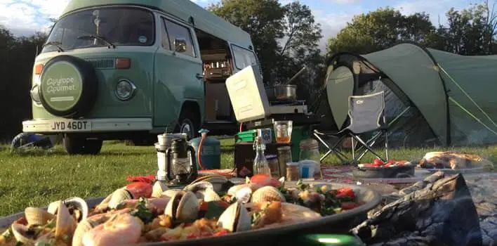 RV camp , chair and table showcasing camping food ideas