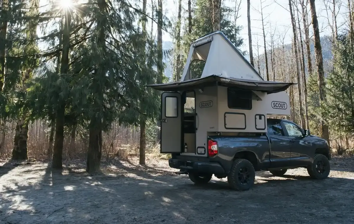 Best Lightweight Truck Campers (2026): 15 Picks That Won't Overload Your Truck 4 Scout Yoho pop-up slide-in camper with canvas walls raised at a forest camp