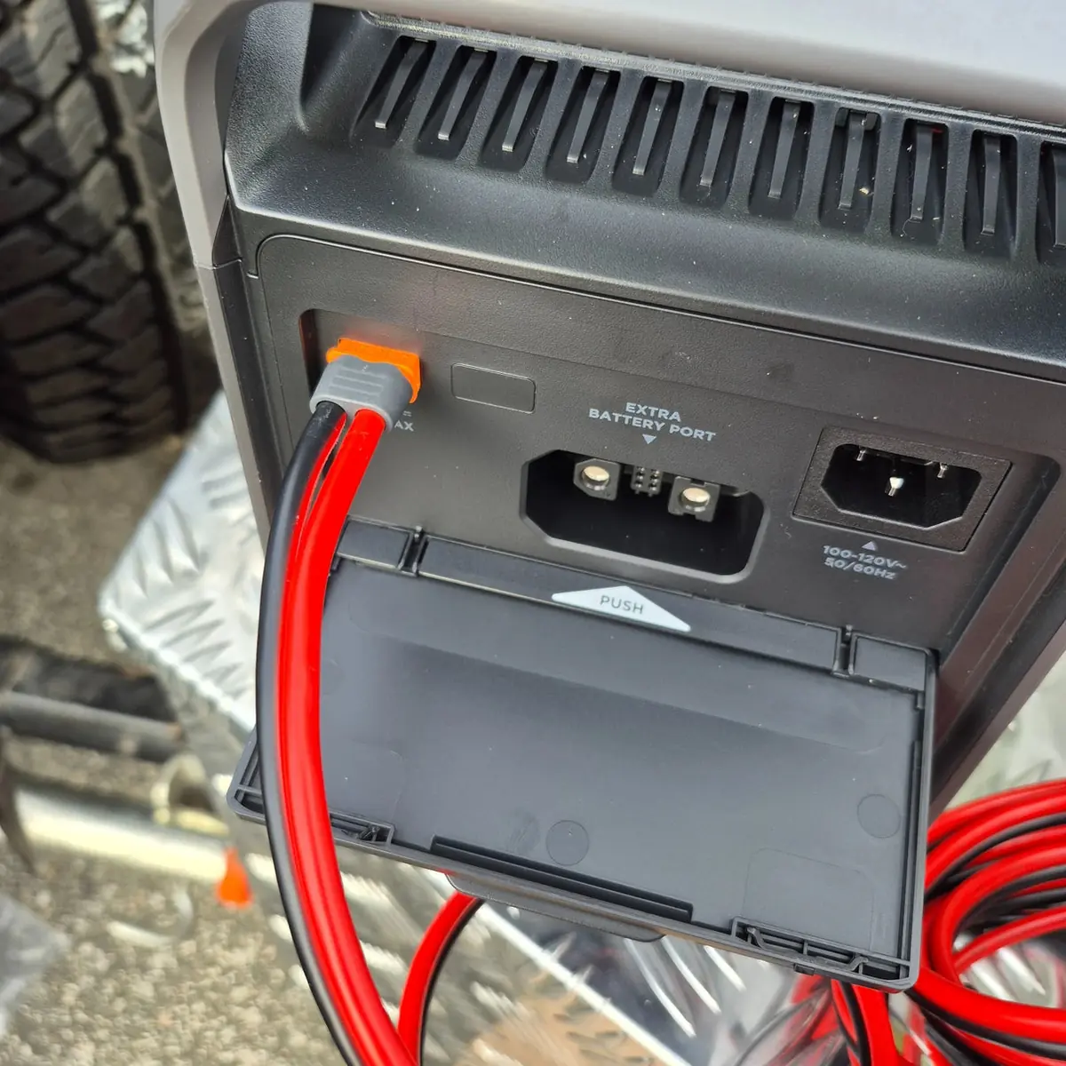 Close-up of EcoFlow Delta 3 input panel with solar cable connected beside the AC input port
