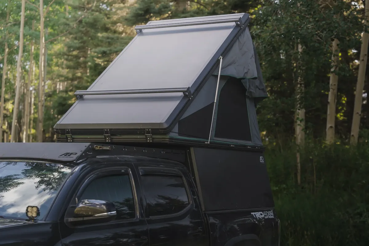 The 7 Best Wedge Campers & Canopy Campers for 2026 (Real Prices, Real Weights) 8 Madix Drift wedge camper with tent open on a Toyota Tacoma