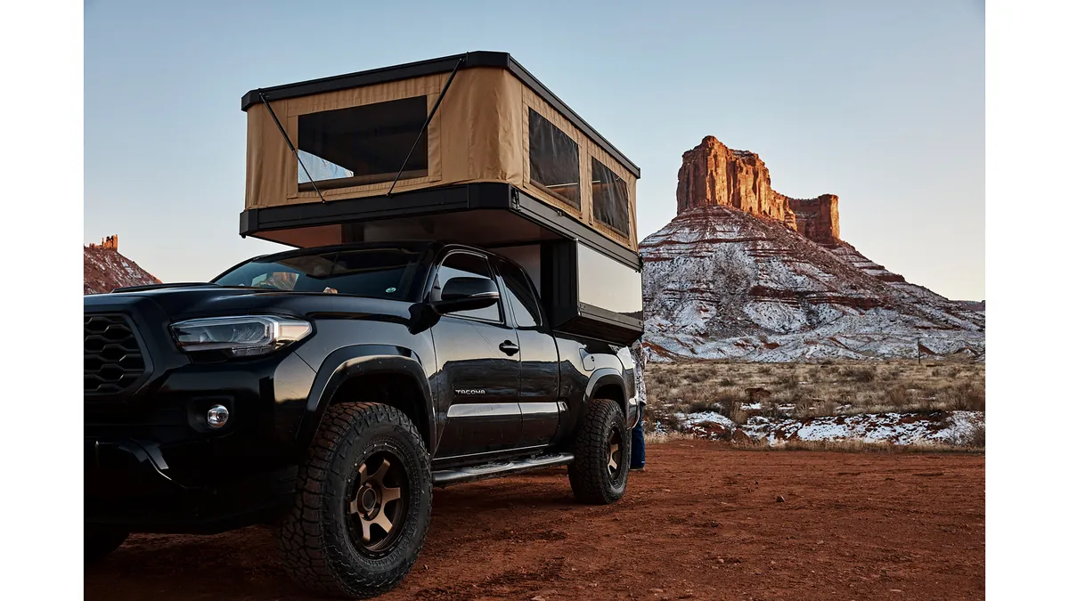 The 7 Best Wedge Campers & Canopy Campers for 2026 (Real Prices, Real Weights) 4 Tune M1 pop-top truck camper with roof raised