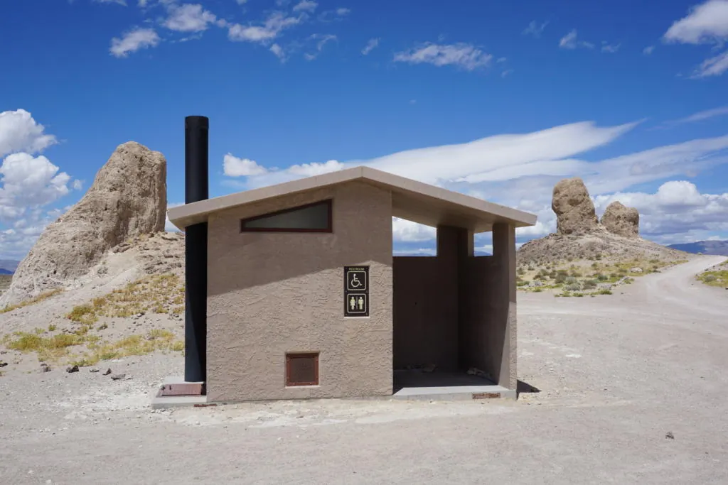 Cassette Toilets for Truck Camper Boondocking: The Complete Honest Guide 3 Vault toilet rest area on a desert two-lane road