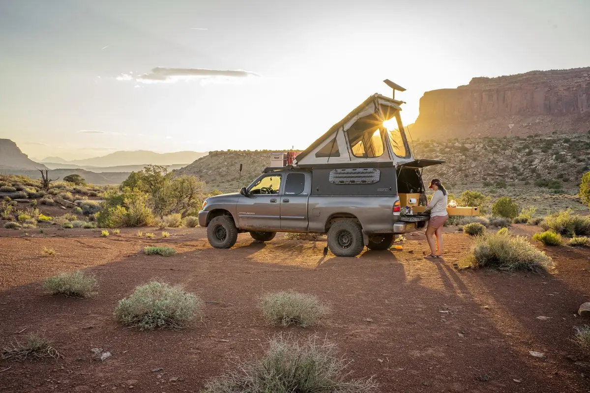 The 7 Best Wedge Campers & Canopy Campers for 2026 (Real Prices, Real Weights) 1 Pickup truck with wedge camper popped open at a mountain campsite