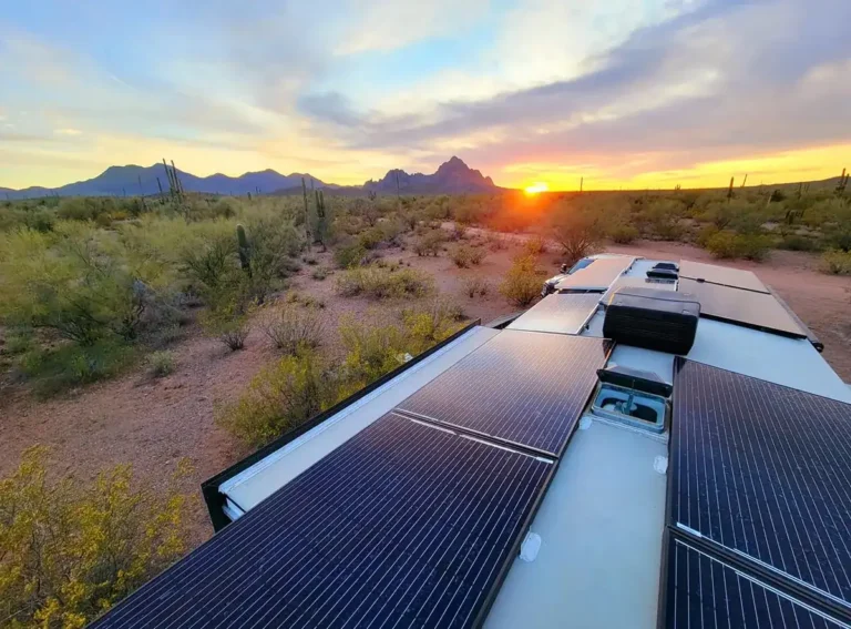 Solar panels mounted on a truck camper roof at golden hour