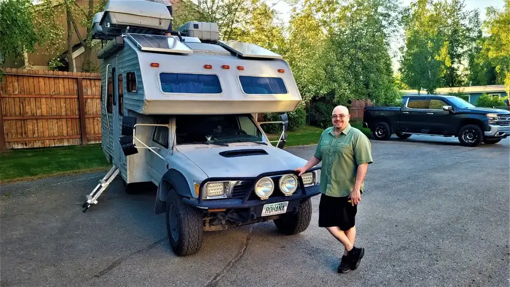 Truck Camper Theft Prevention: A Security Guide That Actually Works 9 Truck camper loaded on a pickup truck parked in a home driveway at dusk