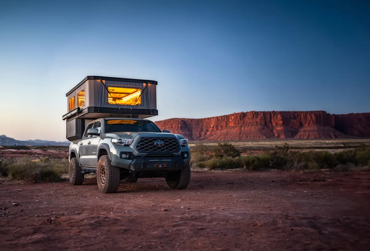 Tune M1 Pop-Up Truck Camper Review: 2026 Hands-On Verdict 1 Tune M1 pop-up truck camper fully deployed on a Toyota Tacoma at a desert campsite at dusk