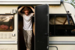 Truck Camper for Tall People: What Actually Works at 6'2" and Up 3 Tall man standing upright in a truck camper doorway checking headroom