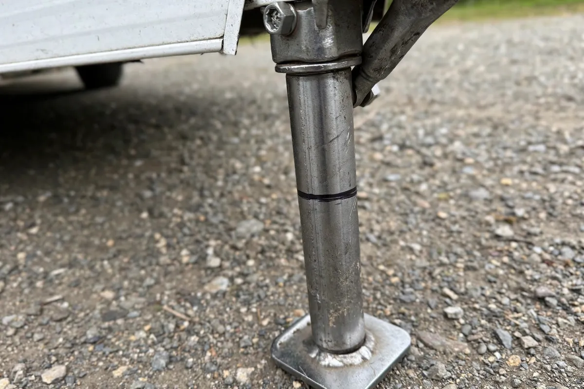 How to Load a Truck Camper by Yourself: The Nose-High Rule, Wind Limits, and When to Abort 3 Camper jack leg with a permanent marker height line for repeatable solo loading height