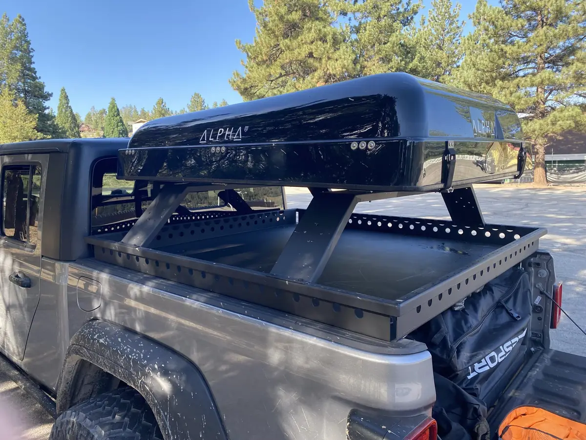 Best Truck Campers for Jeep Gladiator (2026) — What Actually Fits 7 Closed hard-shell rooftop tent on a Jeep Gladiator bed rack