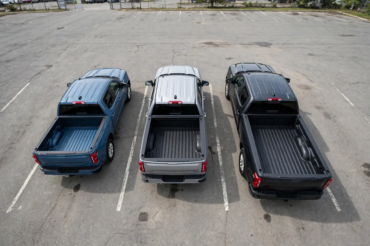 Three crew cab pickup trucks with short, standard and long beds parked side by side