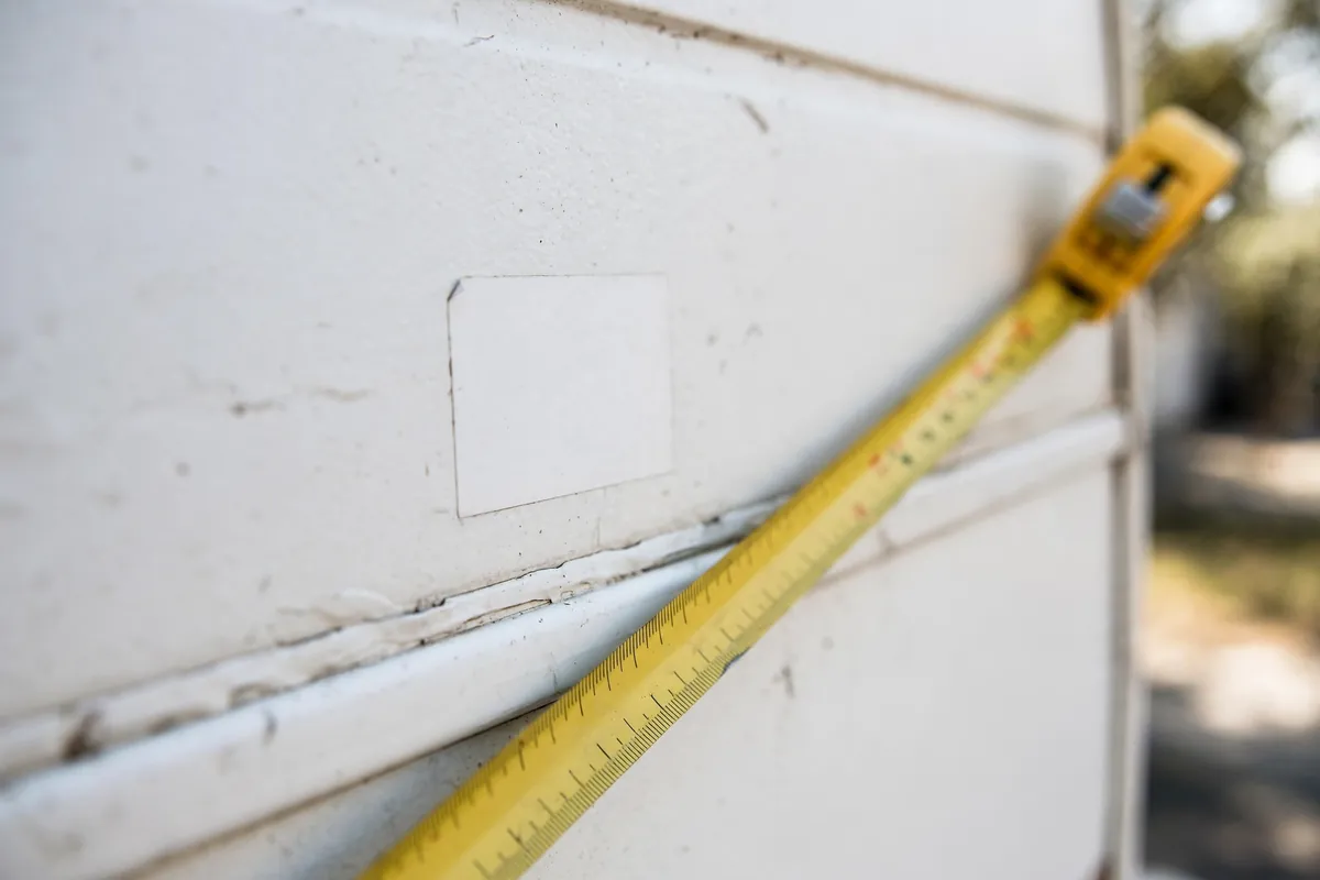 Close-up of a truck camper's center-of-gravity sticker with a tape measure alongside