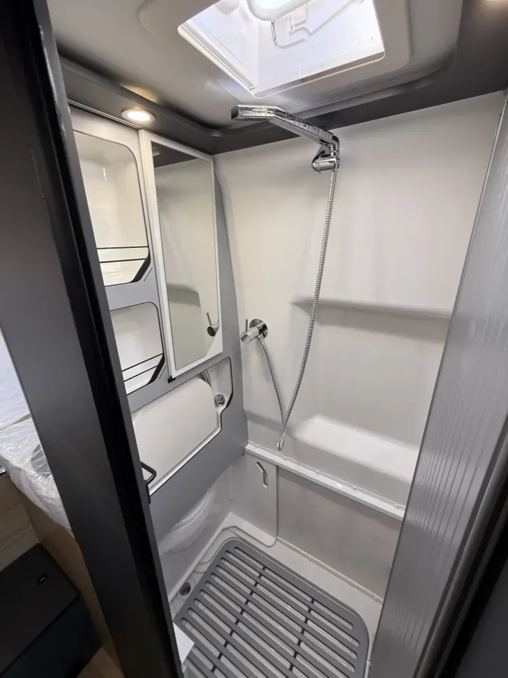Truck Camper for Tall People: What Actually Works at 6'2" and Up 7 Compact truck camper wet bath with dome skylight overhead adding headroom