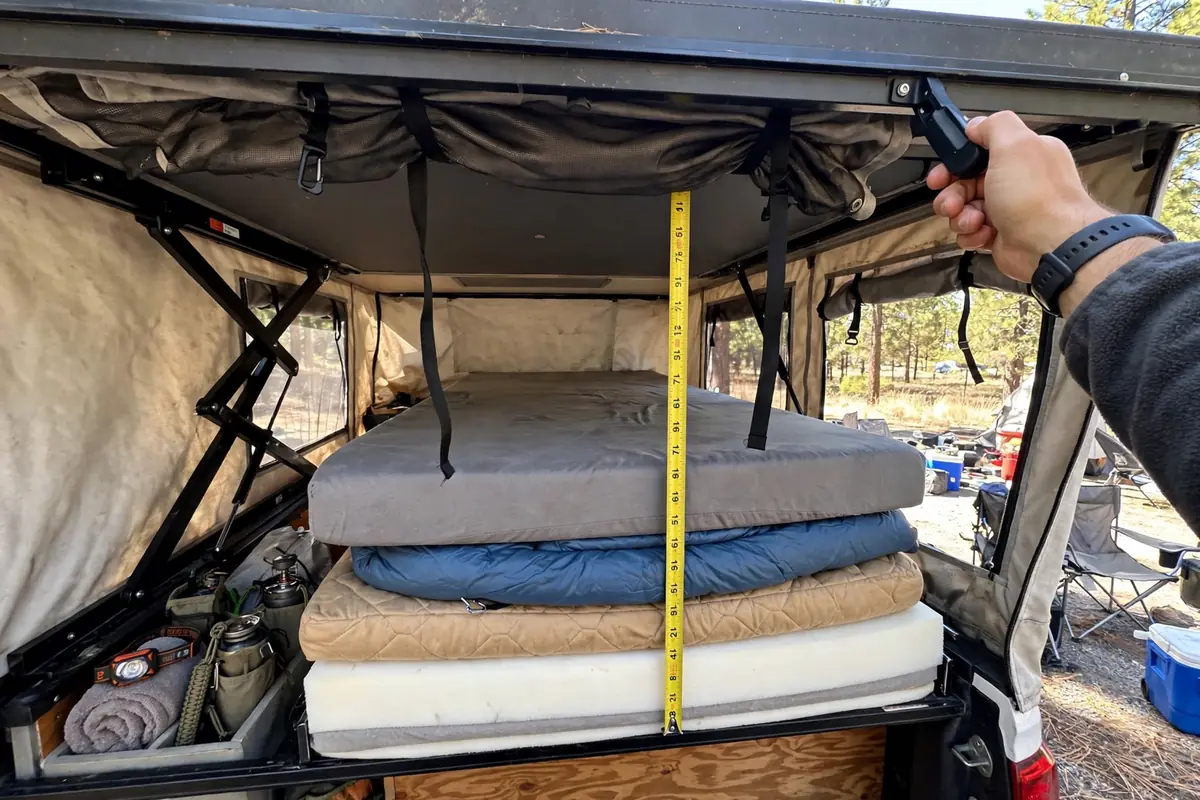 Truck Camper Mattress Upgrade - Fixing the Cabover Sleep Problem 3 Pop-up truck camper roof lowered over cabover mattress stack showing clearance at a campsite