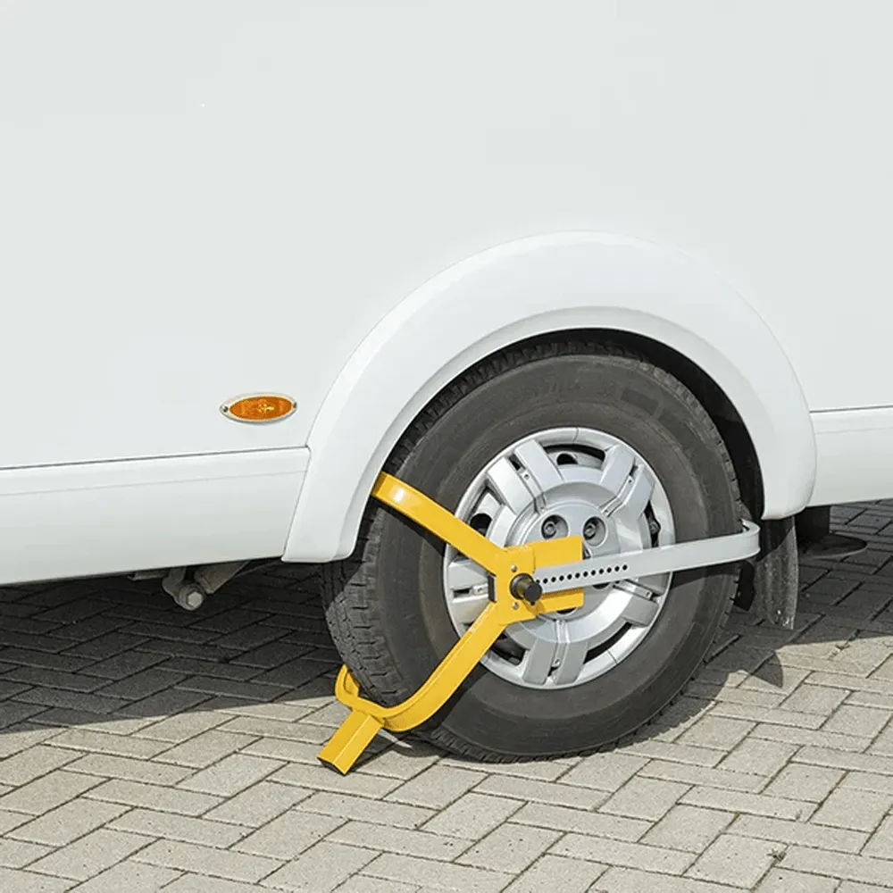 Truck Camper Theft Prevention: A Security Guide That Actually Works 3 Bright yellow wheel chock lock clamped onto a camper tire