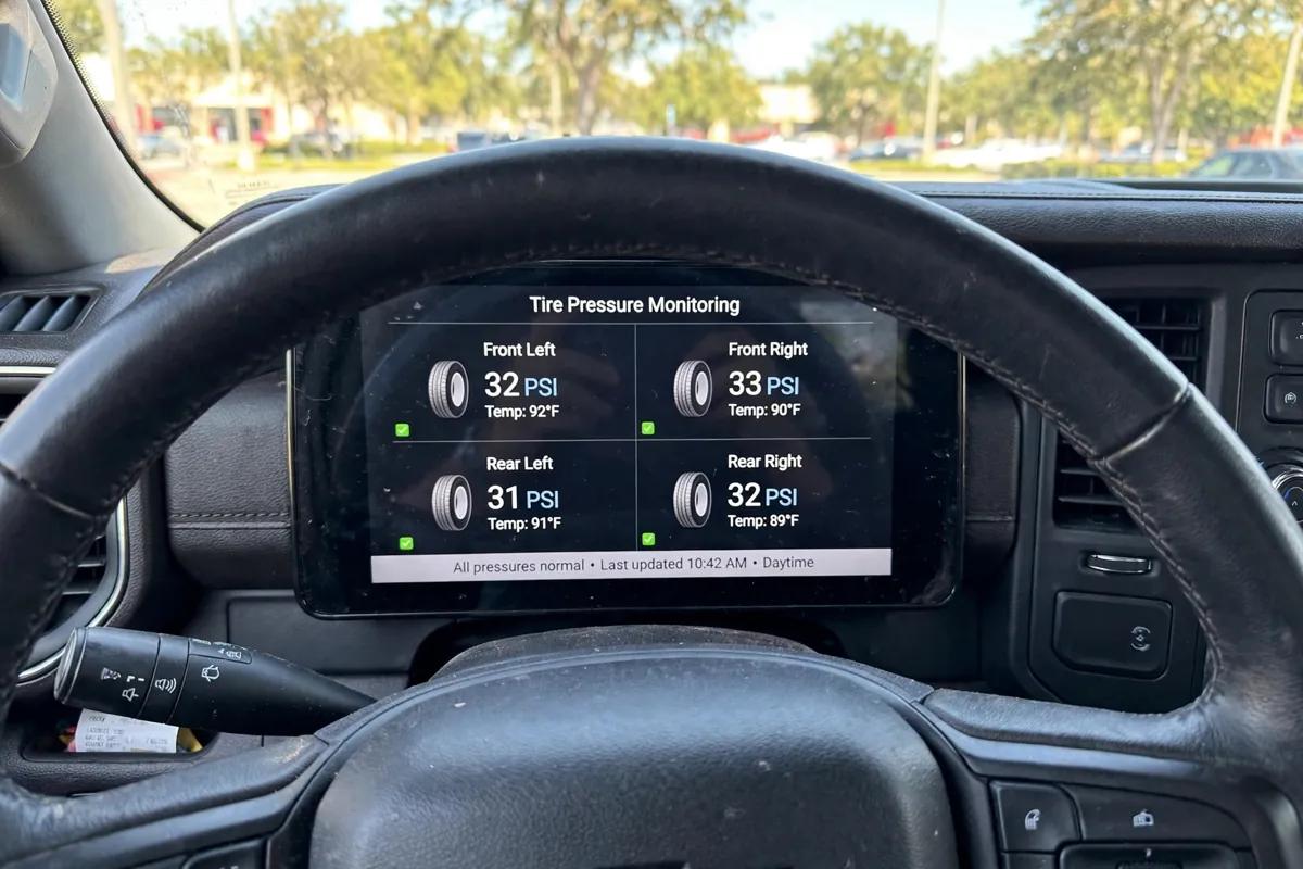 Truck dashboard TPMS display showing per-tire pressure and temperature readings