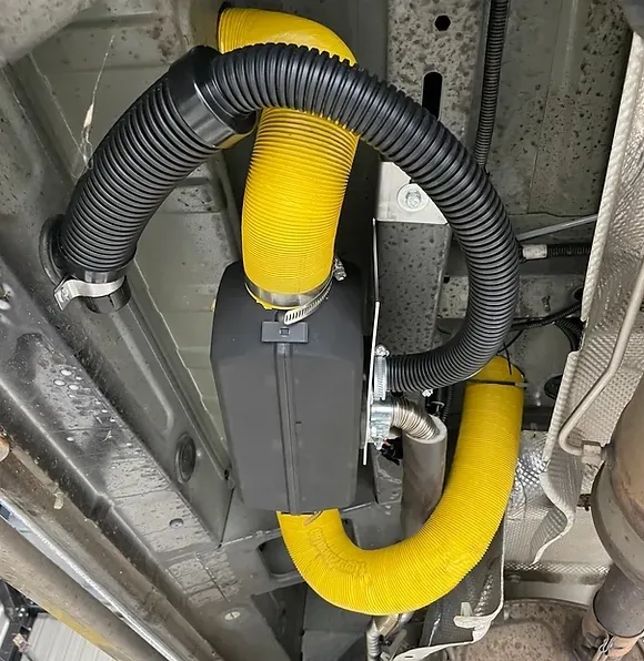 Unbiased Winter Heating Guide: Truck Camper Heater — Diesel vs Propane vs Electric 2 Compact 12V diesel air heater installed inside a camper, with exhaust pipe and fuel line connected
