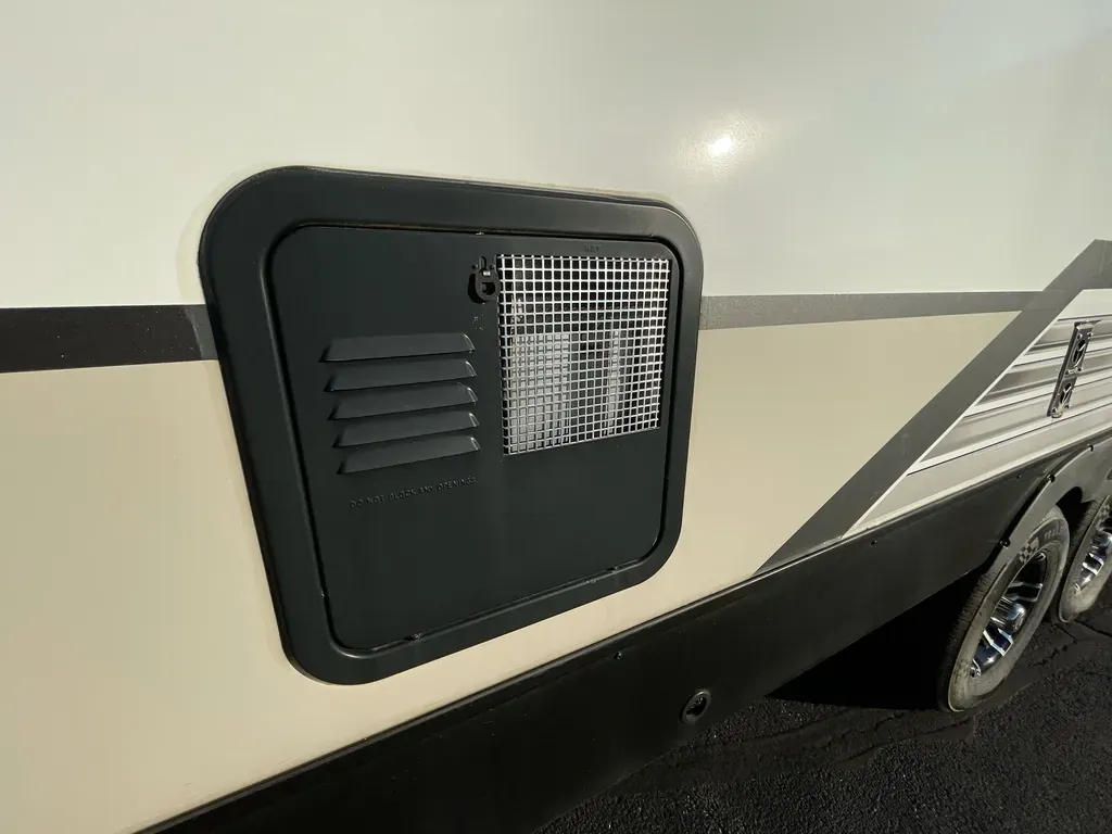 Unbiased Winter Heating Guide: Truck Camper Heater — Diesel vs Propane vs Electric 3 Suburban-style RV furnace exterior vent grille on the side wall of a camper