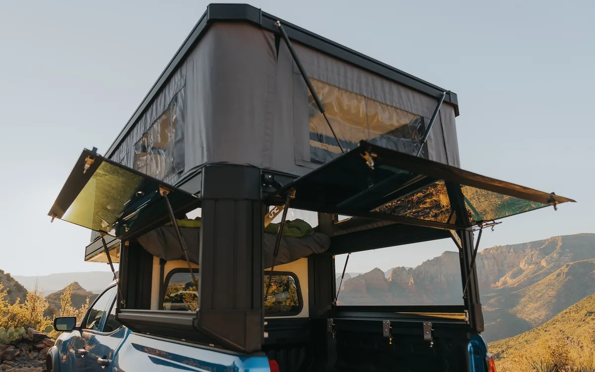 Tune M1 Pop-Up Truck Camper Review: 2026 Hands-On Verdict 4 Tune M1 with optional smoked glass awning doors open on the camper's side