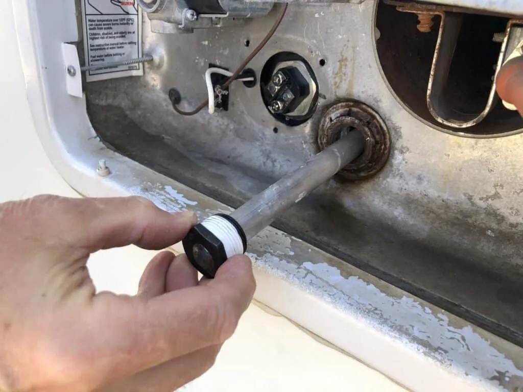 How to Winterize a Truck Camper (2026 Step-by-Step Guide) 4 Removing an RV water heater anode rod to drain the tank